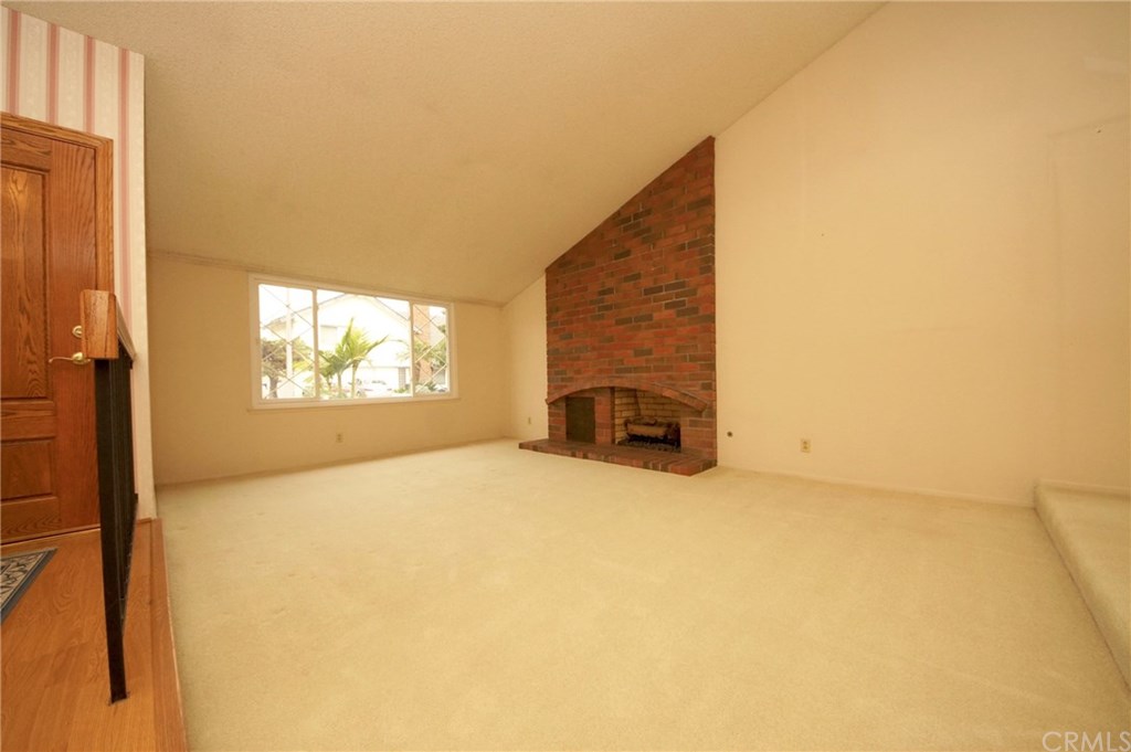 6064 Lawrence Street Cypress, CA 90630 - Photo 2 of 20 Step-down Living Room (note the cozy gas/wood brick fireplace)