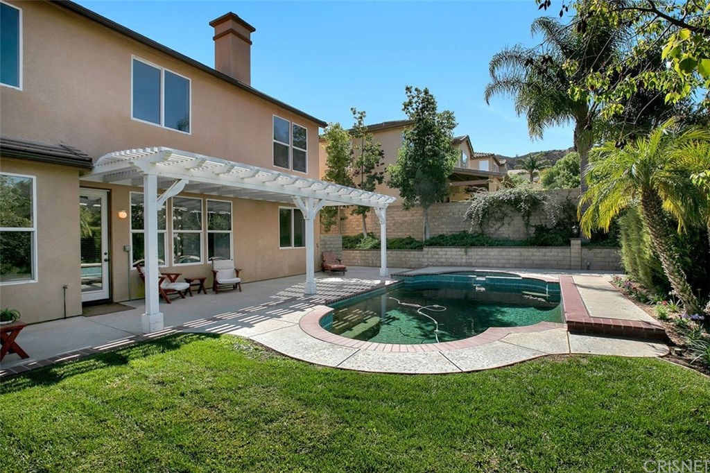 Backyard with mountain views, grassy play area and heated Pebble Tec pool and spa