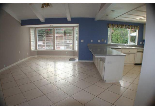 15948 Lime Grove Road Poway, CA 92064 - Photo 4 of 25 Big family room adjoins the kitchen; bay window overlooks pool and spa/deck with door to the right of the bay window leading to the back yard.