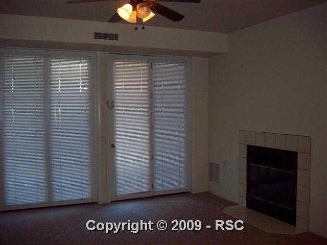 175 West Cheyenne Road, Unit 102 Colorado Springs, CO 80906 - Photo 6 of 11 living room has a gas fireplace and walk out to the patio