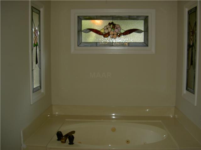 7103 Belsfield Road Memphis, TN 38119 - Photo 14 of 25 Whirlpool tub is surrounded with beautiful leaded glass windows, letting in the light but preserving your privacy.