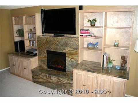 649 Paradise Lane Colorado Springs, CO 80904 - Photo 4 of 13 Large living room with new built-ins and marble fireplace