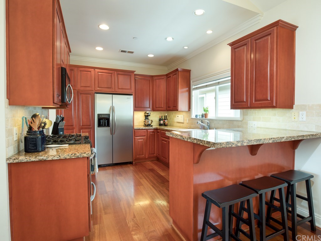 2302 Grant Avenue, Unit 2 Redondo Beach, CA 90278 - Photo 14 of 29 Chef’s kitchen that features a breakfast bar seating