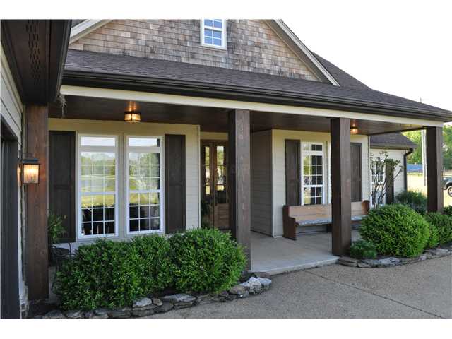 The home is professionally landscaped and the soaring front door welcomes visitors to this unique country setting.