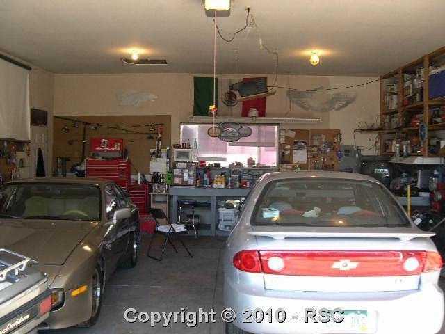 925 Sunset Road Colorado Springs, CO 80909 - Photo 14 of 15 Inside view of heated garage with work shop area