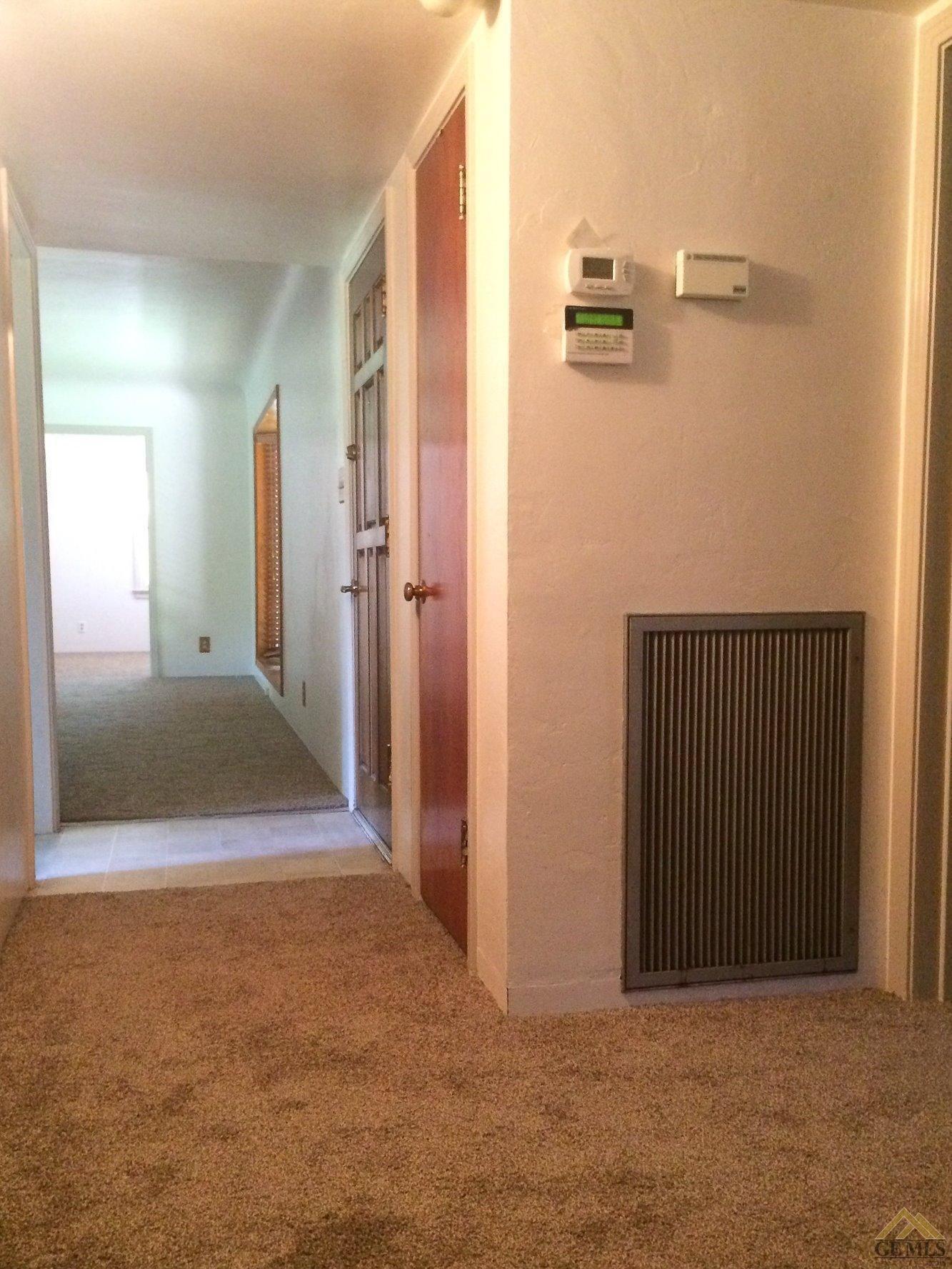 1733 Locust Ravine Bakersfield, CA 93306 - Photo 12 of 33 Looking from the bedrooms toward the living room. Note the security system control panel and programable thermostat for the central A/C and Heat.