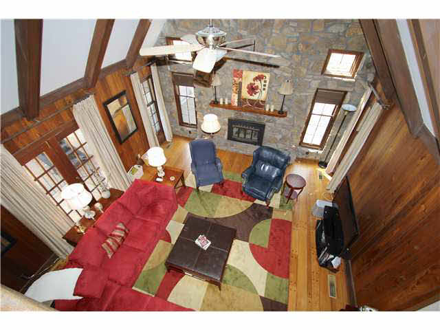 2288 Kirby Road Memphis, TN 38119 - Photo 8 of 25 View of the great room from upstairs. Notice how the stone goes all the way to the ceiling. With the wood walls, beamed ceiling and stone fireplace it feels like you are on vacation at a lodge.