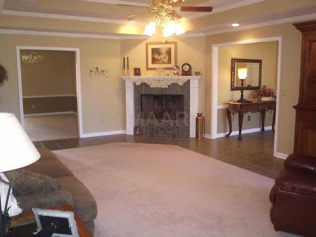Entertain family and friends in the Formal Dining Room, Separate Living Room or Inviting Great Room warmed by fireplace and accented by ceramic tile flooring with carpet inlay, double tray ceiling, and recessed lighting.