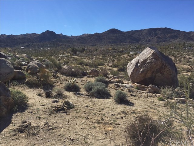 8140 Skyline Drive Joshua Tree, CA 92252 - Photo 4 of 27 The south view from the five acres interior. Your new home project could set here among the rocks.