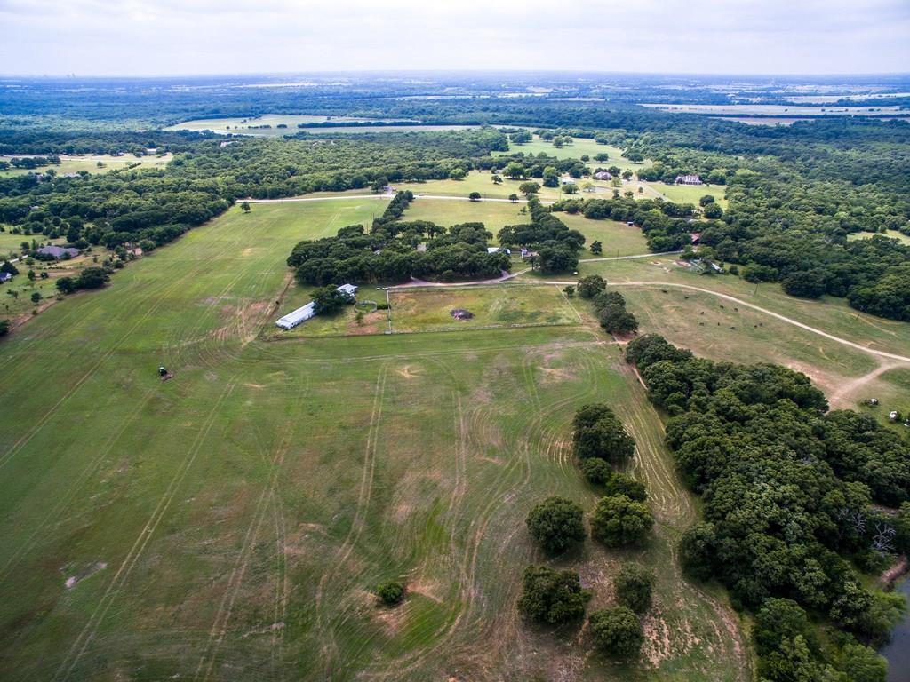 4478 Wildcat Road Aubrey, TX 76227 - Photo 1 of 1 Large horse barn is visible with corral and riding arena. Property can be subdivided.