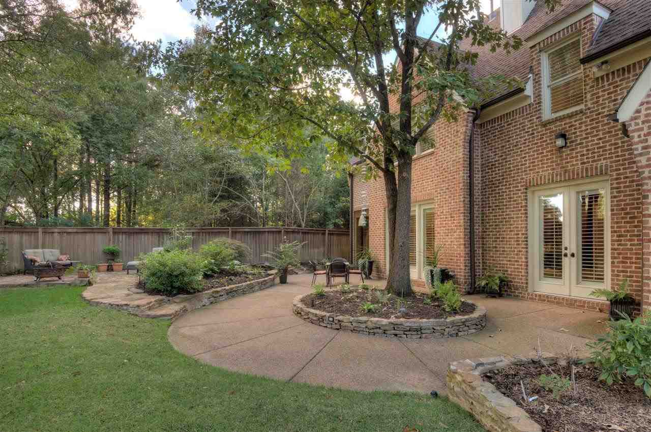 1277 South Dubray Place Collierville, TN 38017 - Photo 21 of 25 Spectacular private back yard is complimented with stacked stone flower beds, velvet green lawn plus a separate patio with fire pit.