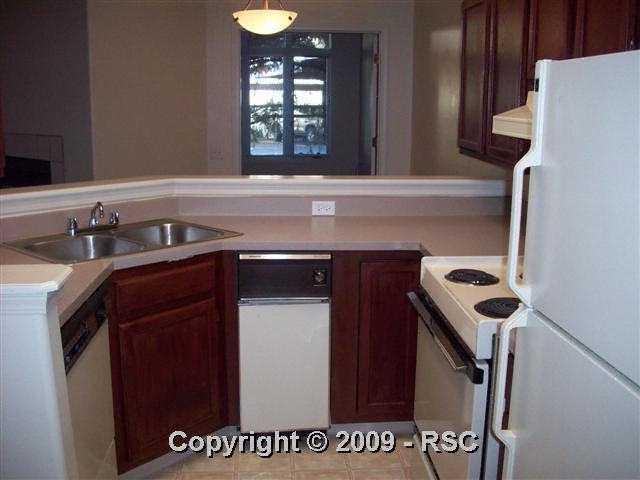 175 West Cheyenne Road, Unit 102 Colorado Springs, CO 80906 - Photo 5 of 11 kitchen has a see through to the dining and living rooms