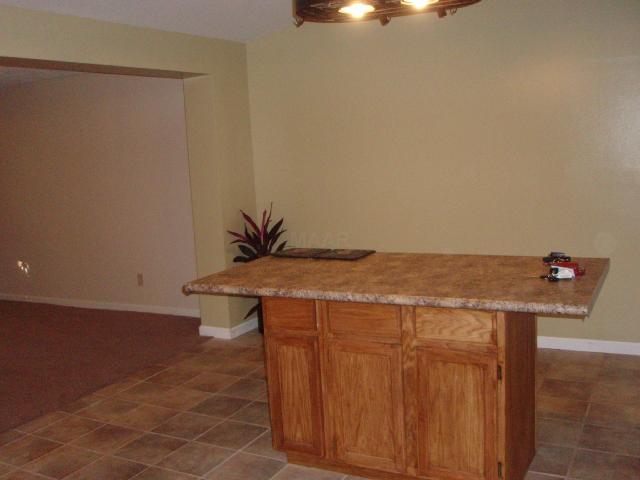 4645 Neely Road Memphis, TN 38109 - Photo 7 of 10 Beautiful island with breakfast bar accentuate the large kitchen. New ceramic tile, cabinets, and countertops and fresh paint make the kitchen warm and inviting. The kitchen has been gutted and redesigned to accomodate a better layout.