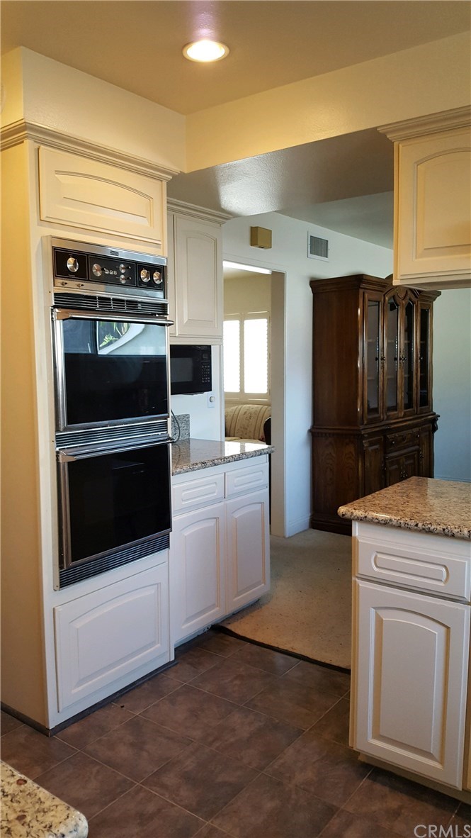 15744 Marlinton Drive Whittier, CA 90604 - Photo 23 of 52 Double ovens, pull out shelves under gas stove cabinet