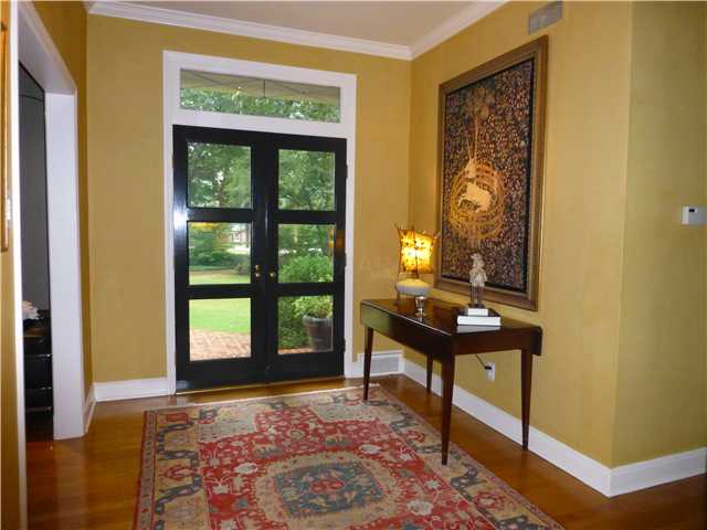 556 Cherry Road Memphis, TN 38117 - Photo 2 of 23 Stunning Glass French doors with leaded glass transom allows an abundance of natural light into the foyer and views through the home to the gardens beyond. Gleaming hardwood foyer and high ceilings welcome you to this striking foyer.