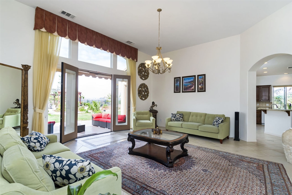 908 Bellagio Road Escondido, CA 92027 - Photo 7 of 25 Another View of HUGE Formal Living Room with DOUBLE DOORS TO BACKYARD and Arched Doorway to FAMILY ROOM AND KITCHEN! This Room Can Be Used as a Formal Living Room Only or as a COMBO Formal Living Room and Formal Dining Room!