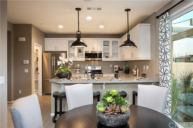 7413 Garnet Ridge Road Jurupa Valley, CA 92509 - Photo 1 of 1 Model photography of open kitchen, walk-in pantry and dining area