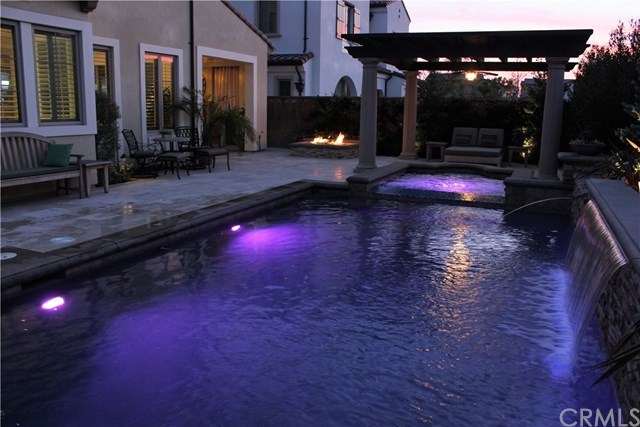 17 Rawhide Irvine, CA 92602 - Photo 36 of 56 Top of the line salt water pool features large waterfall, LED lights, connected jacuzzi spa covered by outdoor structure. High end equipment (Pentair and Jandy) with mobile app control of pool features. Cost of private luxury is kept low with 12-panel 3.7 kilowatt solar power ($125 average electric bill including heating and use of pool features).