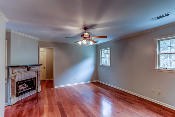 12206 Monterey Road Collierville, TN 38017 - Photo 10 of 25 Exquisite Master Bedroom has hardwood floor, crown molding, ceiling fan, plus vented gas log fireplace with tile surround & decorative wood mantle. Features two walk-in closets and adjoining office area.