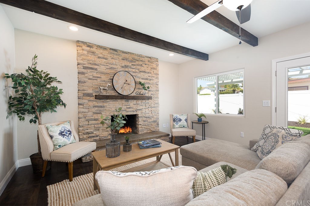 Stacked stone fireplace, exposed beams, custom mantle! Cozy, inviting living room!