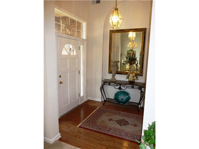 Separate 1.5 story entry with hardwood flooring. Sidelight and transom windows surround the front door.