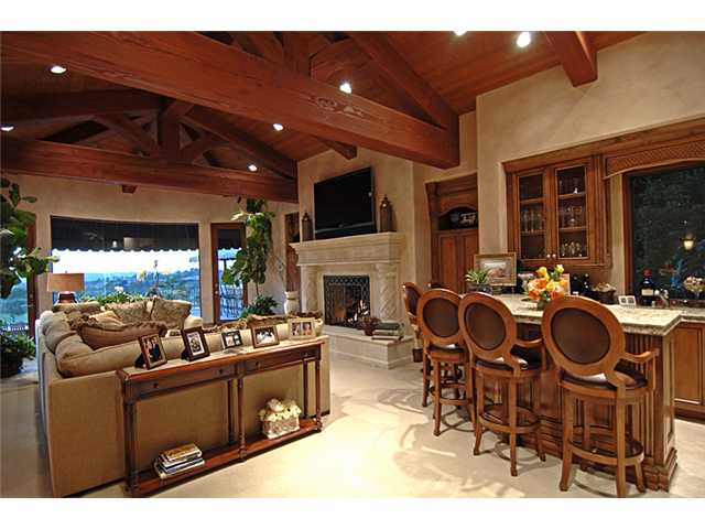 6890 St Andrews Road Rancho Santa Fe, CA 92067 - Photo 3 of 15 Warm great room retreat with large fireplace, television, full wet bar and forever views.
