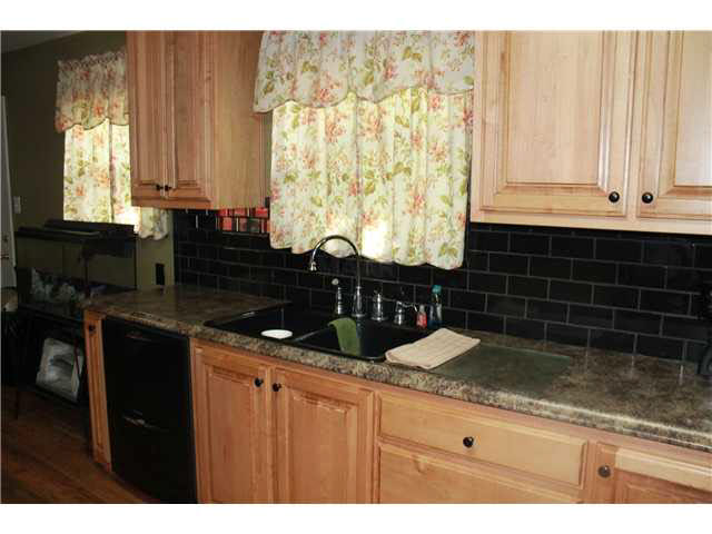 173 Ralph Road Covington, TN 38019 - Photo 5 of 17 backsplash and new countertops and custom made cabinets are a plus in this kitchen