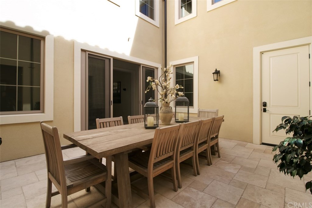17 Rawhide Irvine, CA 92602 - Photo 12 of 56 Open courtyard dining that seamlessly flows from indoor through large sliding glass doors. Courtyard allows for natural light to pour into all angles of the home, making the home bright and airy.
