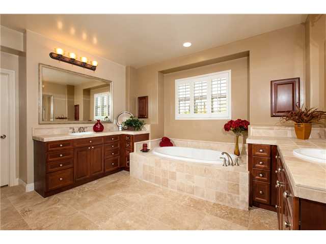 6989 Corte Langosta Carlsbad, CA 92009 - Photo 15 of 25 Master bathroom has travertine floors, shower, tub deck, counter tops and back splashes, cabinets quality doors on the medicine cabinets and custom framed mirrors. There are also 2 separate walk in closets in the master suite.