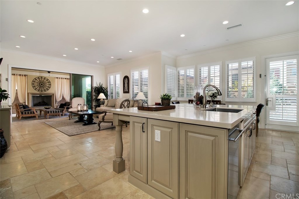 17 Rawhide Irvine, CA 92602 - Photo 6 of 56 Light and bright kitchen with caesarstone island with barstool seating. High-grade painted and glazed cabinetry, gorgeous decorative backsplash, with plenty of countertop and storage, including walk-in pantry. Top of the line stainless steel wolf and sub-zero kitchen appliances.