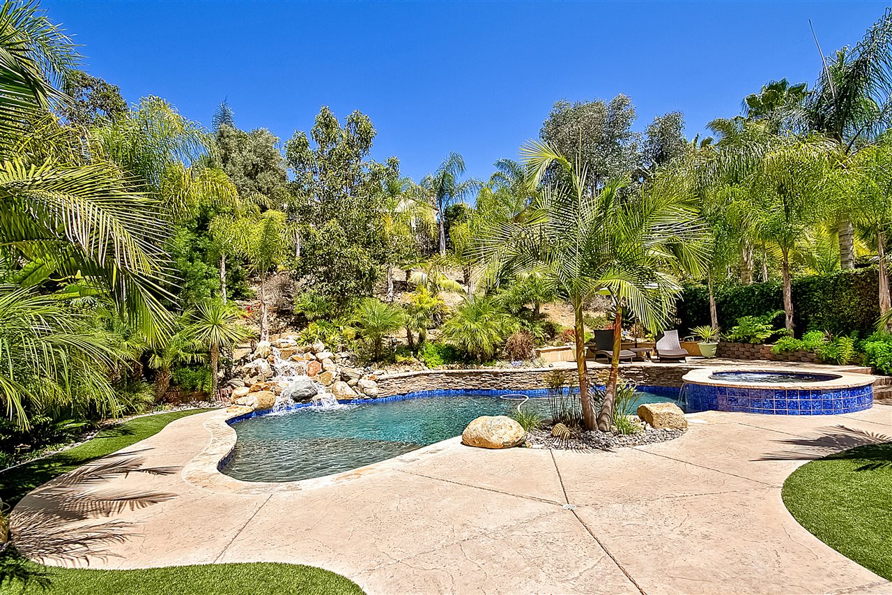 1853 Shadetree Drive San Marcos, CA 92078 - Photo 22 of 25 Custom Salt Water Pool with Large Baja ledge with built in hole for umbrella. Spa with Waterfall feature to pool. Beautiful Rock Waterfall feature to pool.