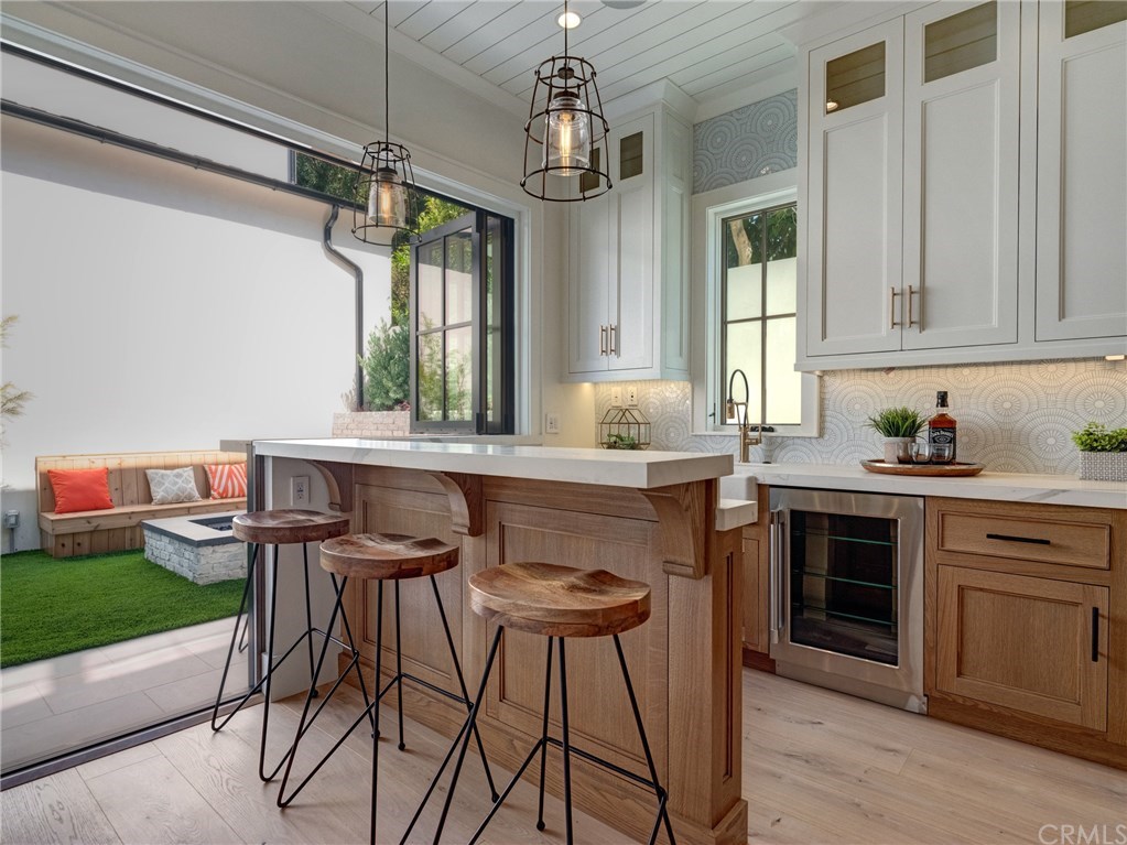 559 31st Street Manhattan Beach, CA 90266 - Photo 9 of 49 Neolith stone counters, Thermador professional series appliances, dual sinks, additional beverage fridge, Brizo faucets, breakfast counter, indoor/outdoor bar & entertainment area that opens to backyard.