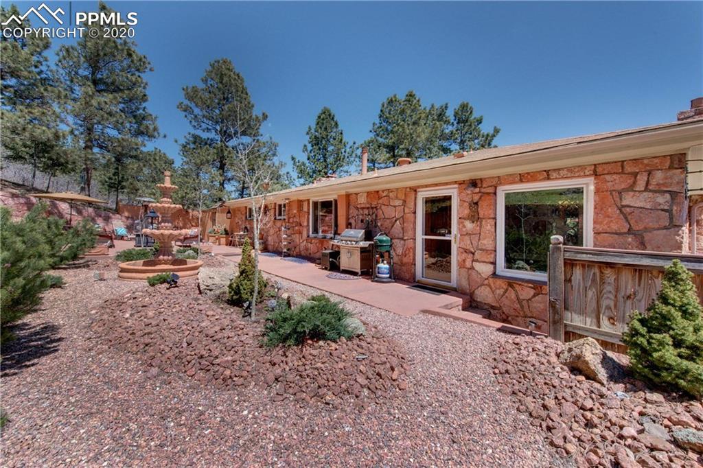 7955 Highway 24 Cascade, CO 80809 - Photo 4 of 36 Beautifully landscaped backyard and patio with large fountain.