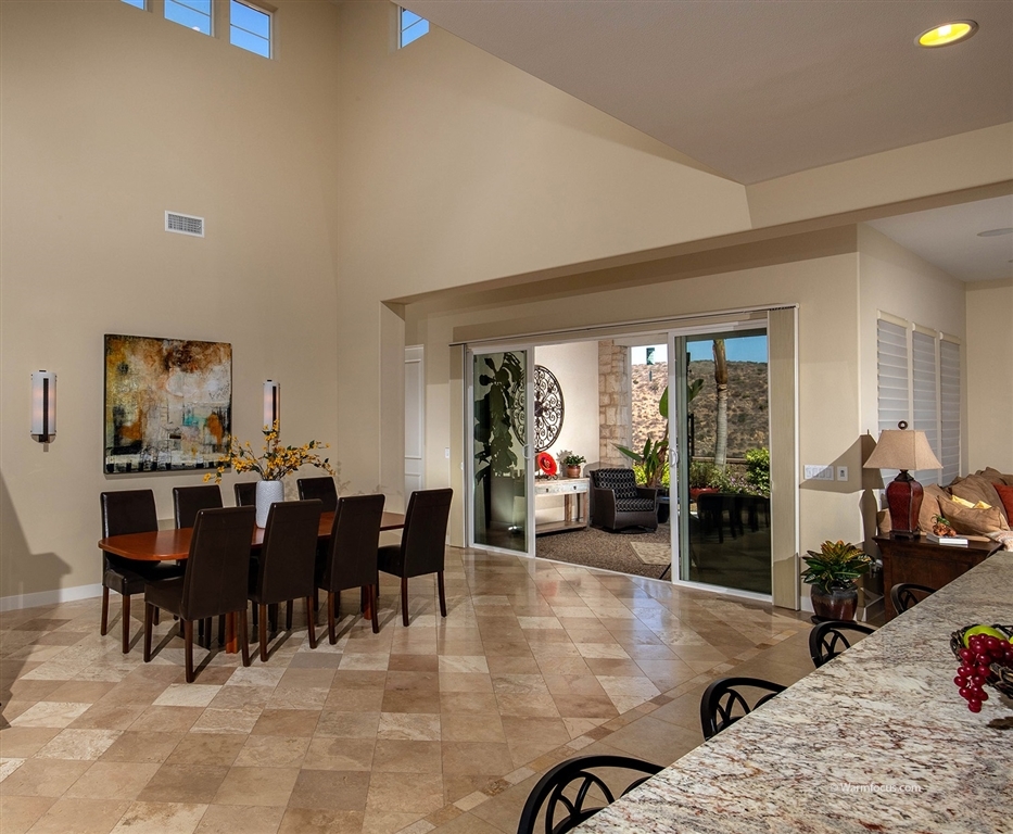 7091 Sitio Caliente Carlsbad, CA 92009 - Photo 4 of 23 Dining Room opens to Outdoor Loggia/Living Room for the best of SoCal Indoor/Outdoor living!