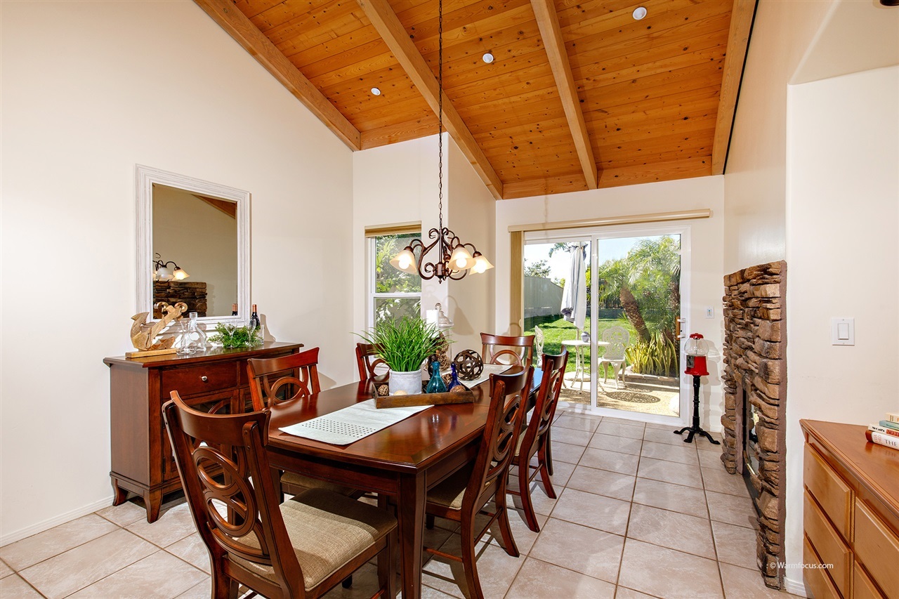 449 Ocean View Avenue Encinitas, CA 92024 - Photo 8 of 23 High ceilings and double sided stone fireplace, tiled flooring in dining room