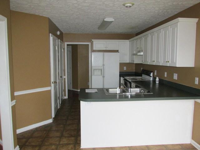 Kitchen with bar and large breakfast area.