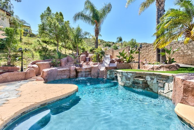 3086 Diamondview Circle Corona, CA 92882 - Photo 2 of 66 It introduces a world of entertainment in the backyard, which features a rock pool and spa with a water slide, multiple water falls and large stamped concreted areas to accommodate gatherings.