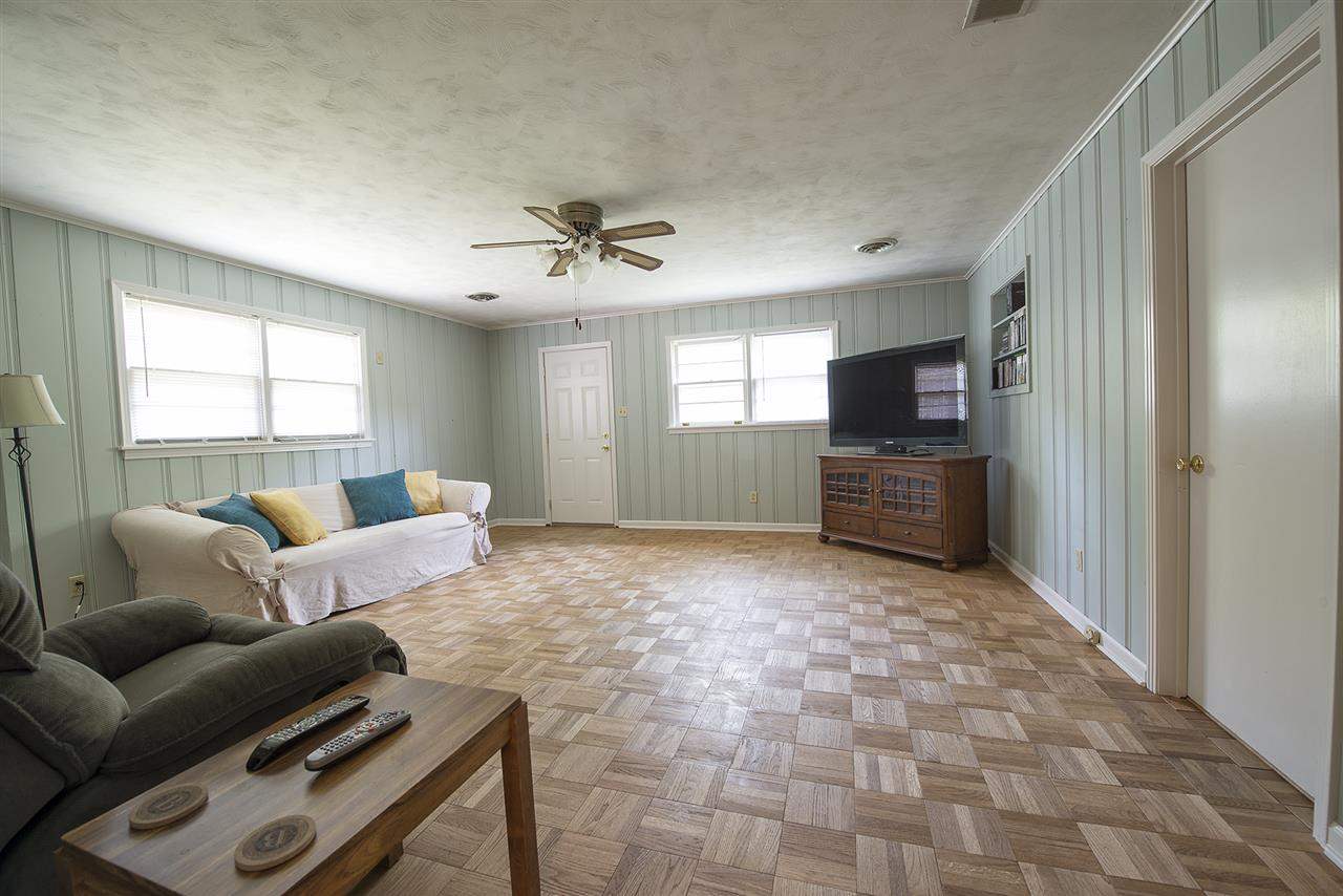 5013 Dee Road Memphis, TN 38117 - Photo 11 of 19 Features hardwood floors, lots of windows for natural light, 2" faux wood blinds, ceiling fan and separate storage closet. This room sets the house apart.