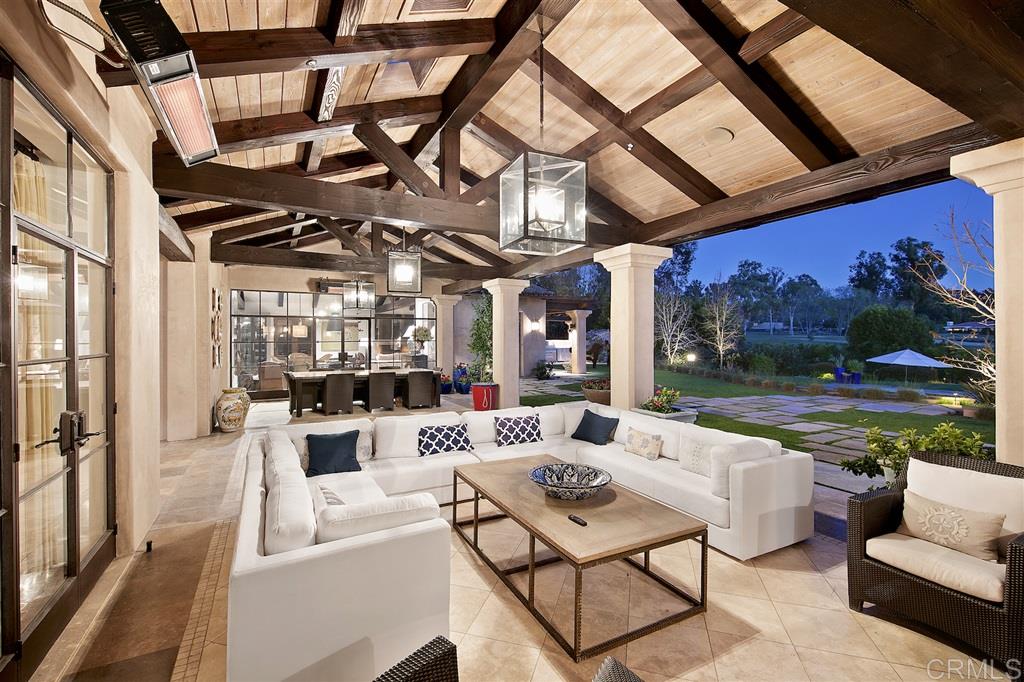 6221 Mimulus Rancho Santa Fe, CA 92067 - Photo 19 of 25 Custom Steel doors lead to generous outdoor living room with separate heated dining area, sitting area with TV and fireplace and sit down Panoramic Golf Course VIEWS!