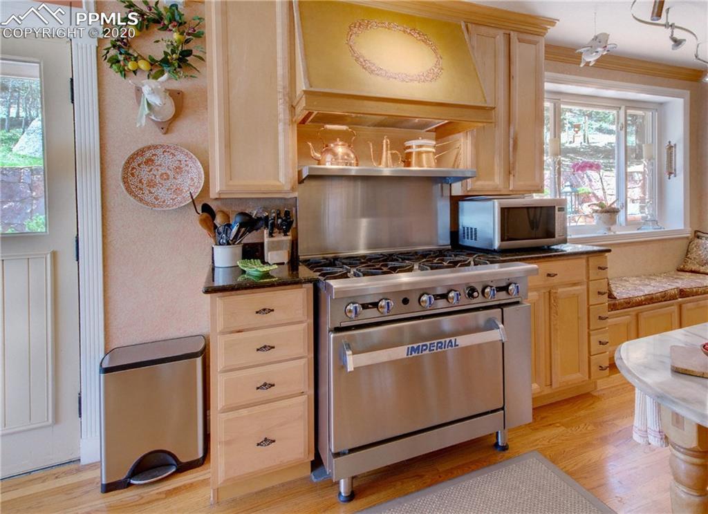 7955 Highway 24 Cascade, CO 80809 - Photo 11 of 36 Kitchen has a professional grade oven, stove and vent.