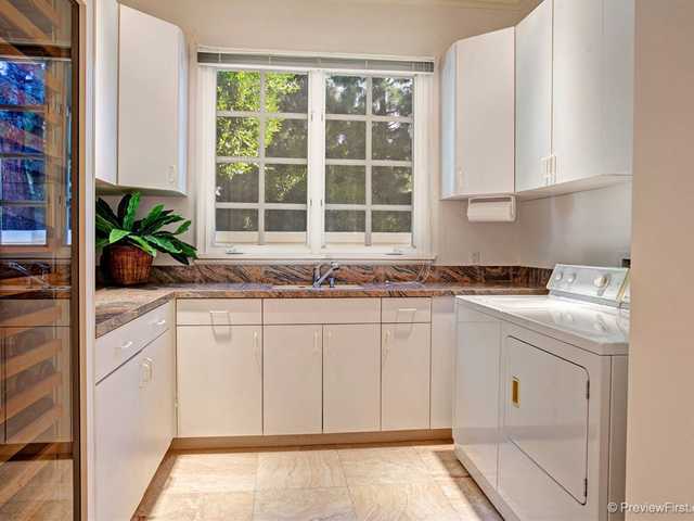 17036 Circa Del Sur Rancho Santa Fe, CA 92067 - Photo 18 of 25 This delightful and large stone trimmed laundry room contains ample storage and a built-in wine closet.
