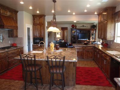 43889 Todd Eymann Road Miramonte, CA 93641 - Photo 8 of 20 Gourmet kitchen with designer granite countertops, massive center island w/veggie sink and disposal. Electric double ovens, Thermador 5 burner gas cook top, Dacor ventilator, Bosch dishwasher, custom knotty Alder cabinets and self-closing cabinets and drawers; an incredible view from the kitchen window overlooking the lake.