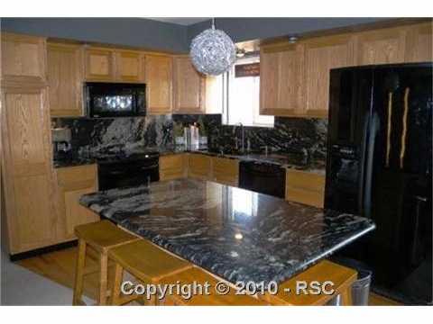 649 Paradise Lane Colorado Springs, CO 80904 - Photo 2 of 13 Kitchen with slab granite and island/breakfast bar