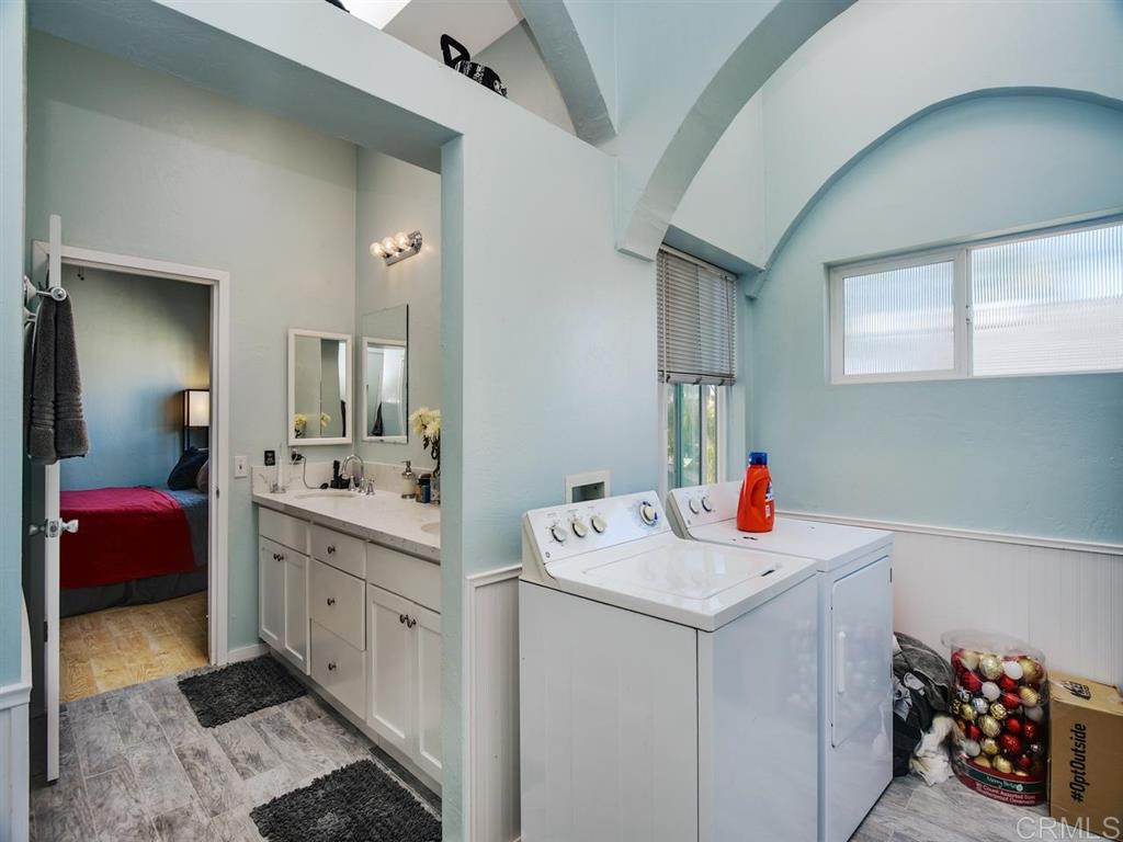 869 Beryl Street San Diego, CA 92109 - Photo 12 of 25 Master bathroom has new dual-sink vanity, walk in shower, separate water closet, and side-by-side laundry.