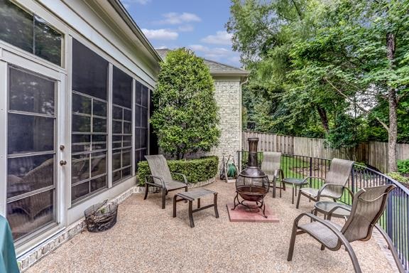 10369 Stoney Brooke Road Collierville, TN 38017 - Photo 23 of 25 Delightful curved patio has curved wrought iron railings and a stone walkway leading to the driveway. Lush professional landscaping.