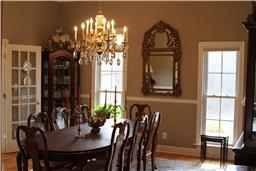 4399 Clear Creek Road Pulaski, TN 38478 - Photo 11 of 25 A large formal dining room exuding grand elegance yet grounded atmosphere | Complimented by intricate dental trim work and chair rail, the dining room color palette brings the room into perfect alignment with current design trends