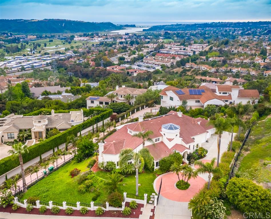Custom estate perched in the La Costa hillside with panoramic views of the golf course, lagoon, and ocean