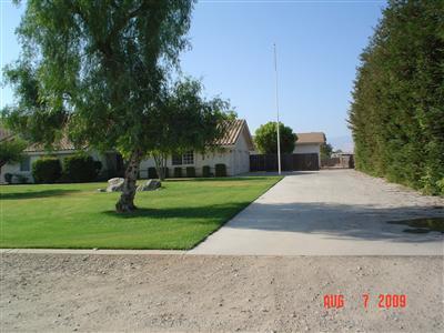 6937 Lindsay Road Bakersfield, CA 93313 - Photo 2 of 15 Lots of concrete & RV pkg leads to the 3-car garage & 28' x 40' stucco shop w/3roll up doors & 3/4 bath