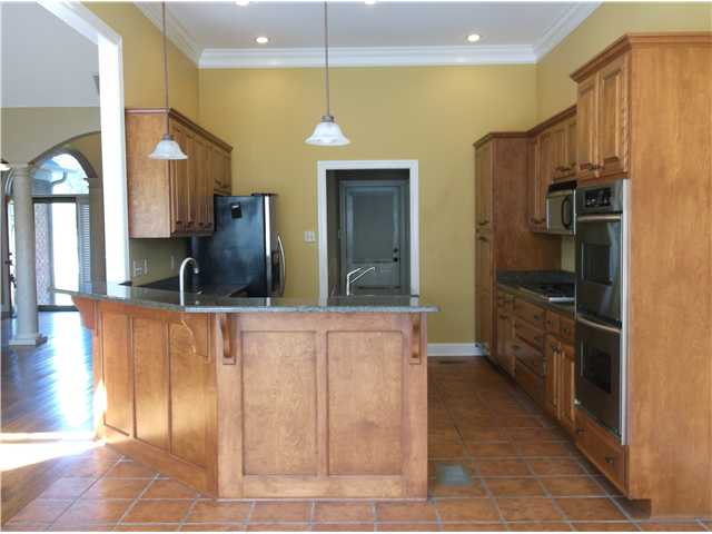 14 Eagle Trace Road Covington, TN 38019 - Photo 15 of 20 Beautiful kitchen with double oven, gas cooktop, microwave, dishwasher, refrigerator, island, and tile floor.