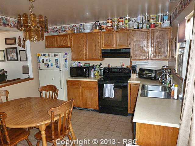 765 Alexander Road Colorado Springs, CO 80909 - Photo 3 of 9 Kitchen Walks Out to Backyard.